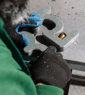 A craftsperson finishing a sculpted piece by hand